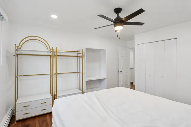 a bedroom with a bed and a dresser