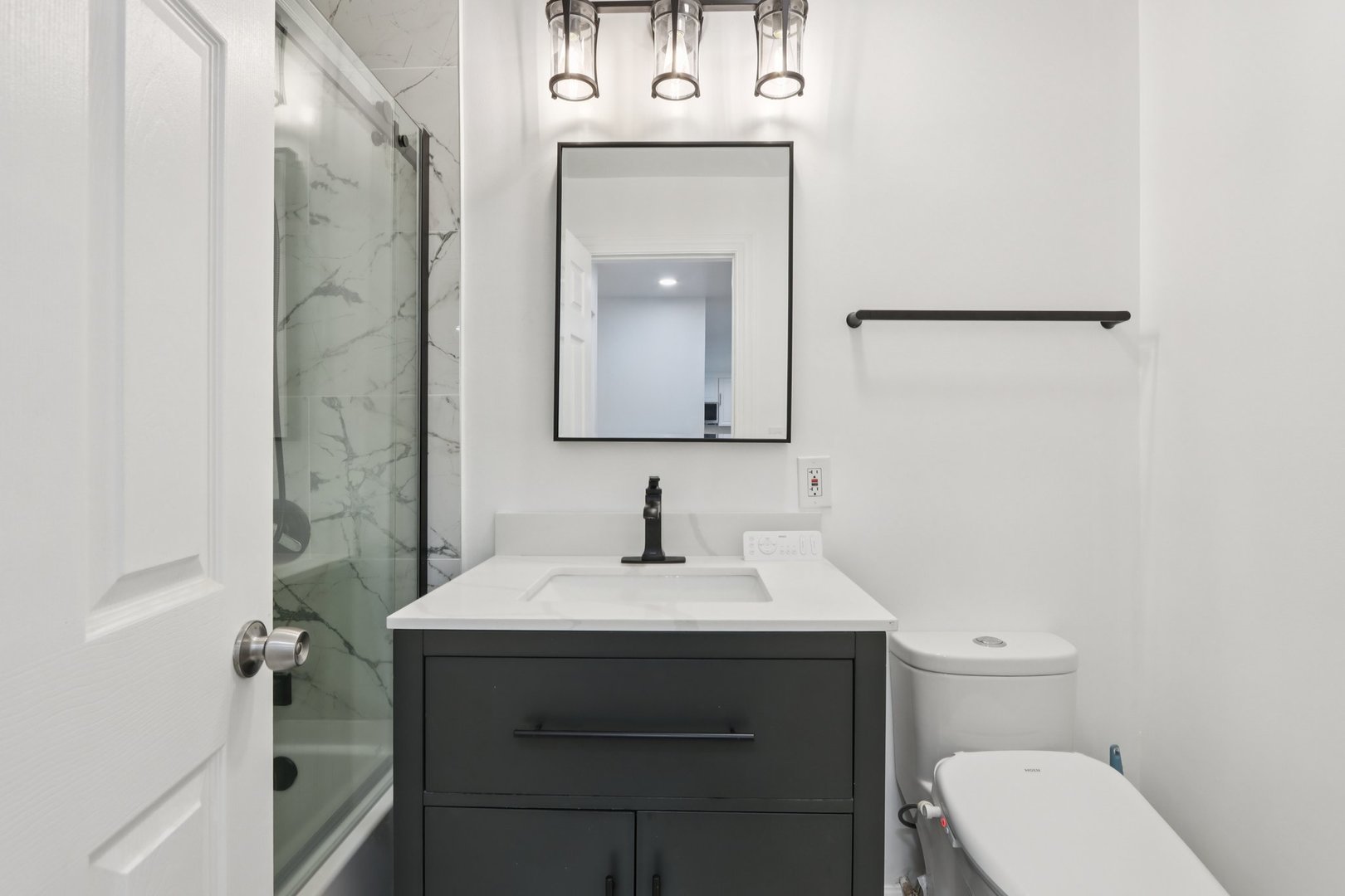 8916 Kenneth Drive, Unit 1E Des Plaines, IL 60016 - Photo 17 of 27 a bathroom with a sink toilet and mirror