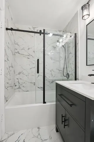 a bathroom with a bathtub and a sink