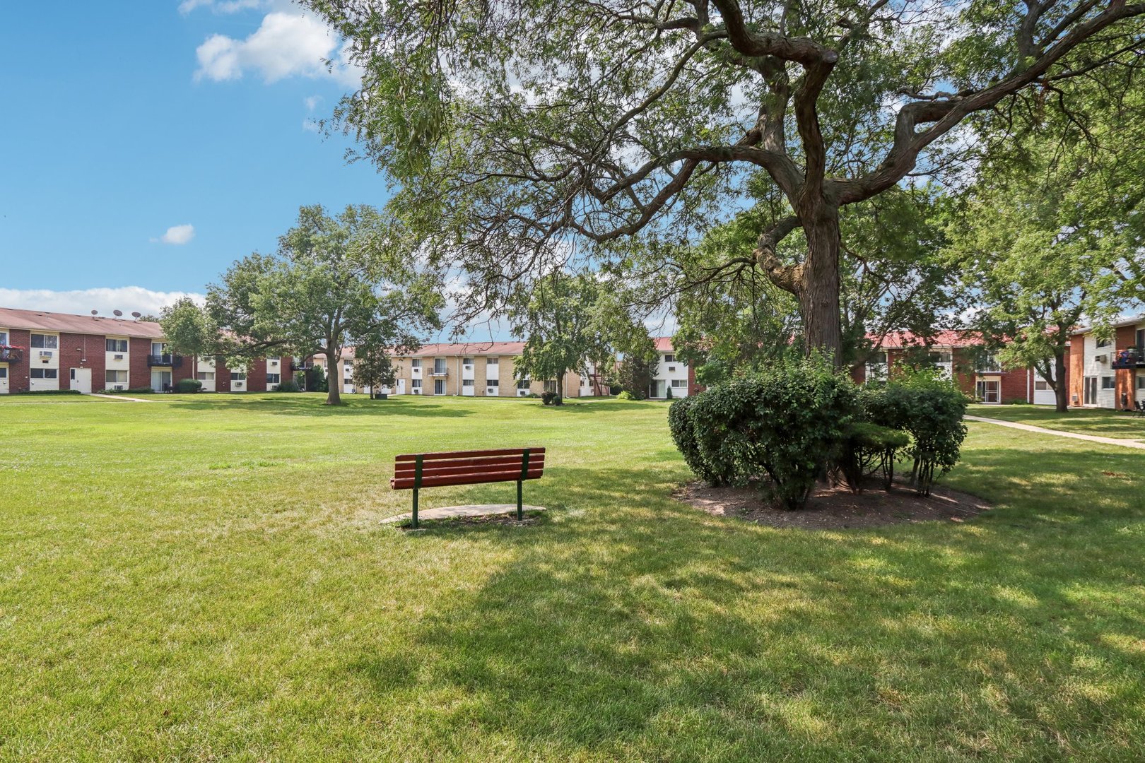 8916 Kenneth Drive, Unit 1E Des Plaines, IL 60016 - Photo 22 of 27 a view of a garden with a bench