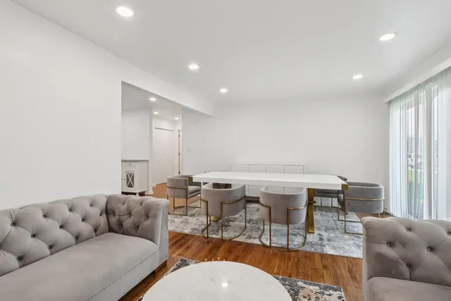 a living room with furniture a window and a table