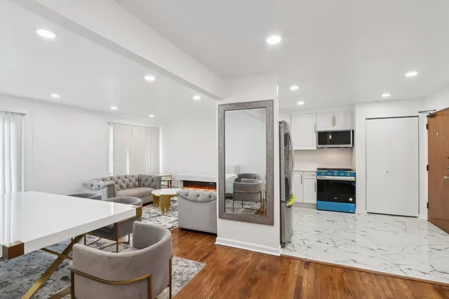a kitchen with stainless steel appliances kitchen island granite countertop a sink and cabinets