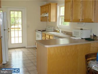 1435 Valley Forge Road Wayne, PA 19087 - Photo 9 of 11 a kitchen with stainless steel appliances a sink a stove and a refrigerator