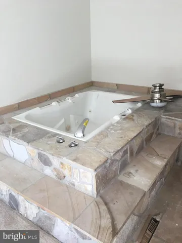 a bathroom with a tub and sink