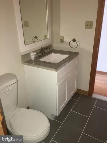 a bathroom with a sink toilet and mirror