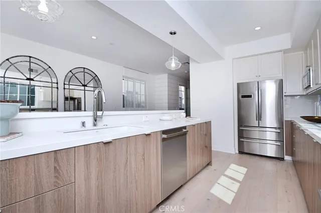 a kitchen with a refrigerator and a sink