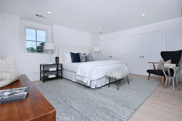 a bedroom with a bed and a couch