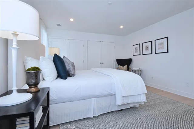 a bedroom with a bed and glass table