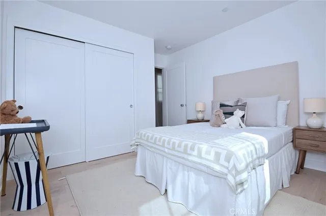 a bedroom with a bed and a mirror