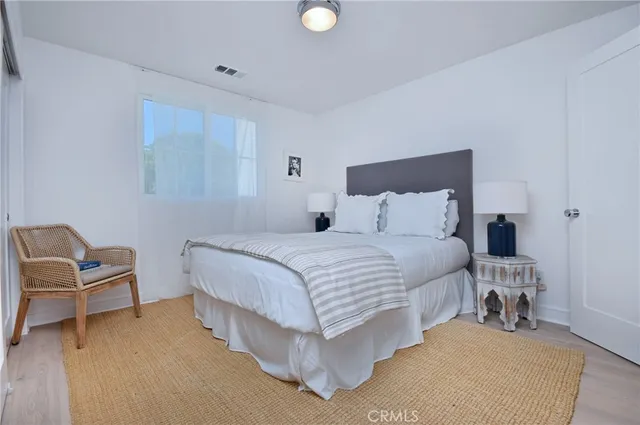 a bedroom with a bed and chair