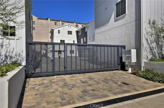 a view of a white house with wooden fence
