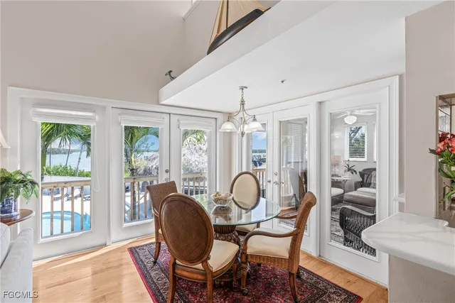 a dining room with furniture a chandelier and wooden floor