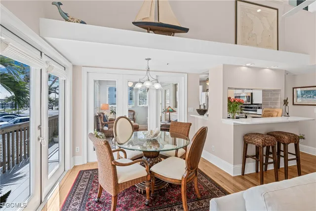a dining room with furniture a chandelier and wooden floor