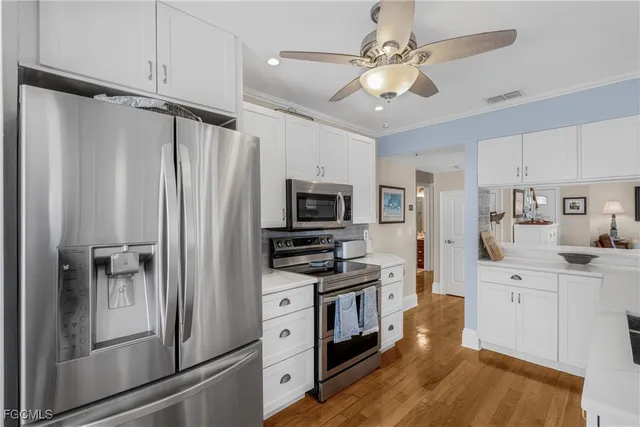 a kitchen with stainless steel appliances a refrigerator stove and microwave