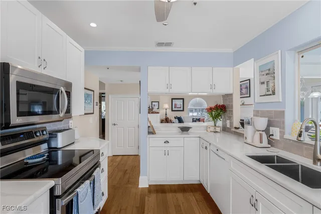 a kitchen with a sink a stove and cabinets
