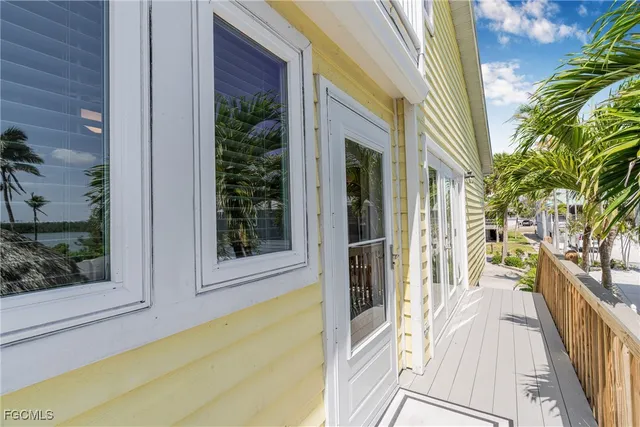 a view of a balcony with wooden floor and chair