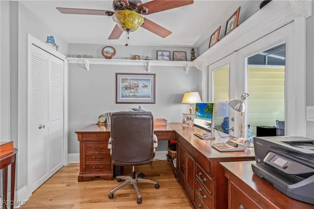 a view of a workspace with furniture and a window