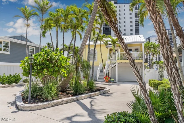 a front view of a multi story building with a yard