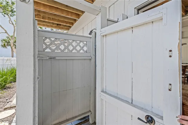 a garage with white cabinets and white appliances