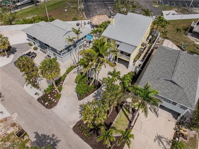 an aerial view of a house with a yard and sitting area