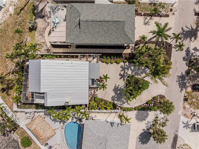 an aerial view of a house with a garden and street