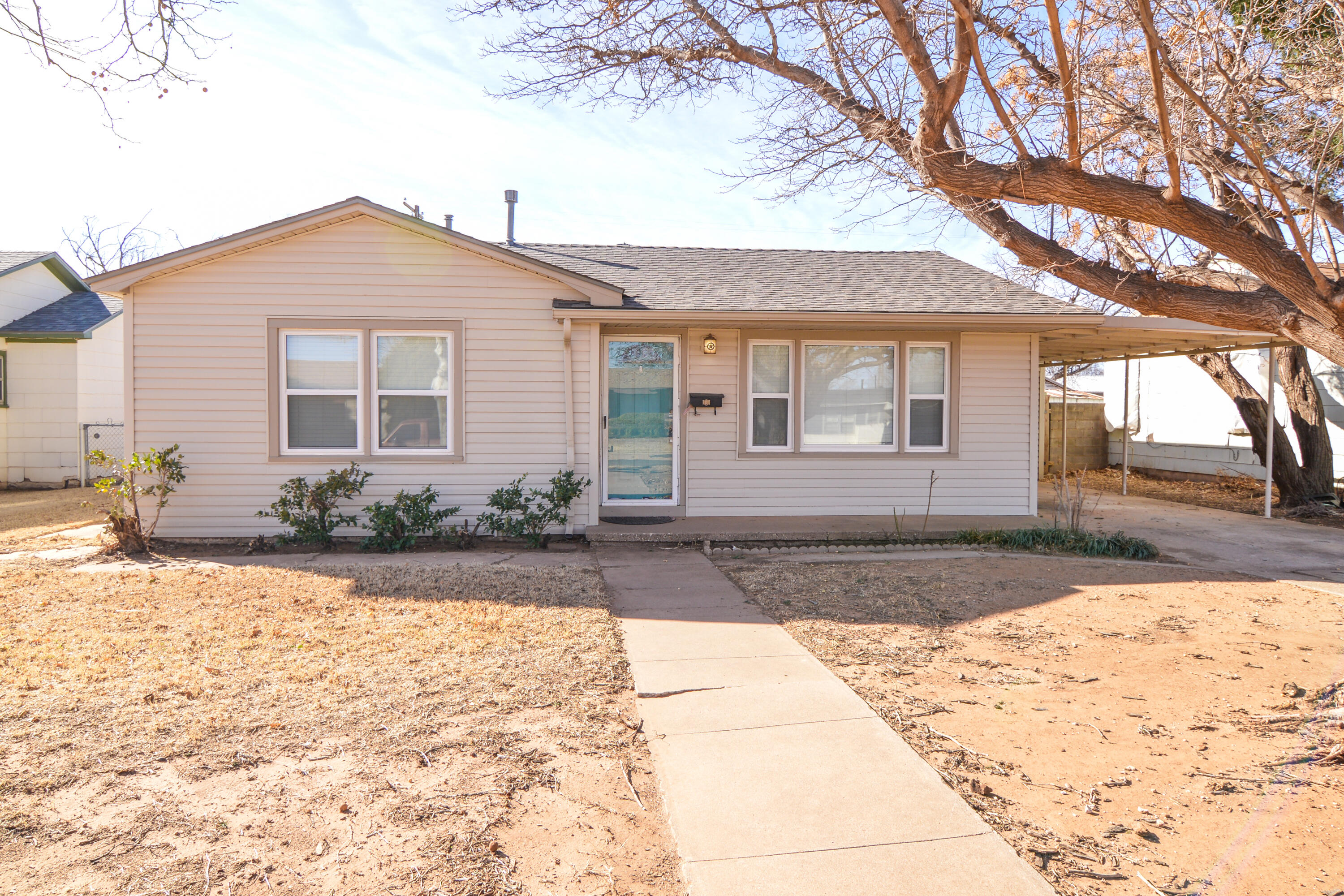 4907 41st Street Lubbock, TX 79414 - Photo 1 of 39 a front view of a house with a yard