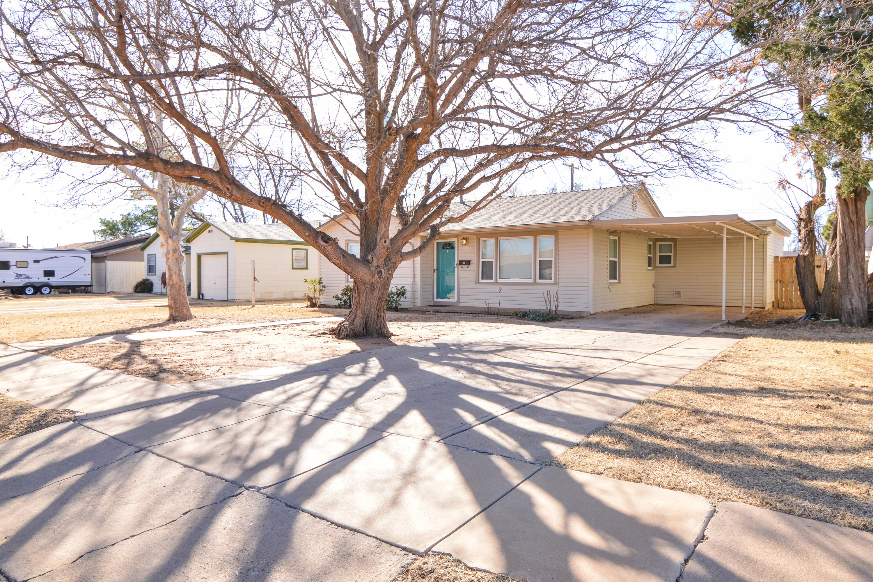 4907 41st Street Lubbock, TX 79414 - Photo 2 of 39 a front view of a house with a yard covered in snow