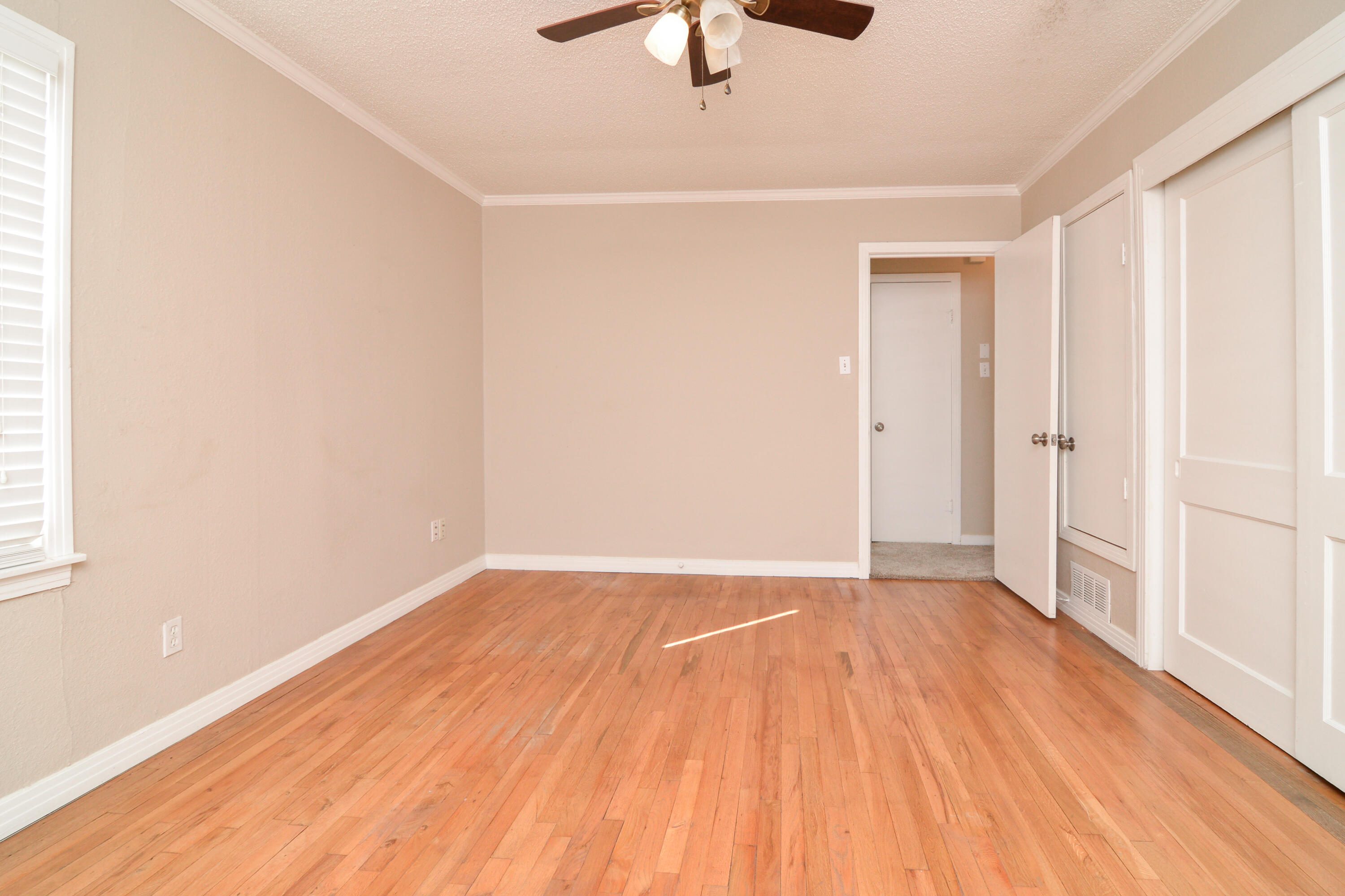 4907 41st Street Lubbock, TX 79414 - Photo 21 of 39 a view of an empty room with wooden floor