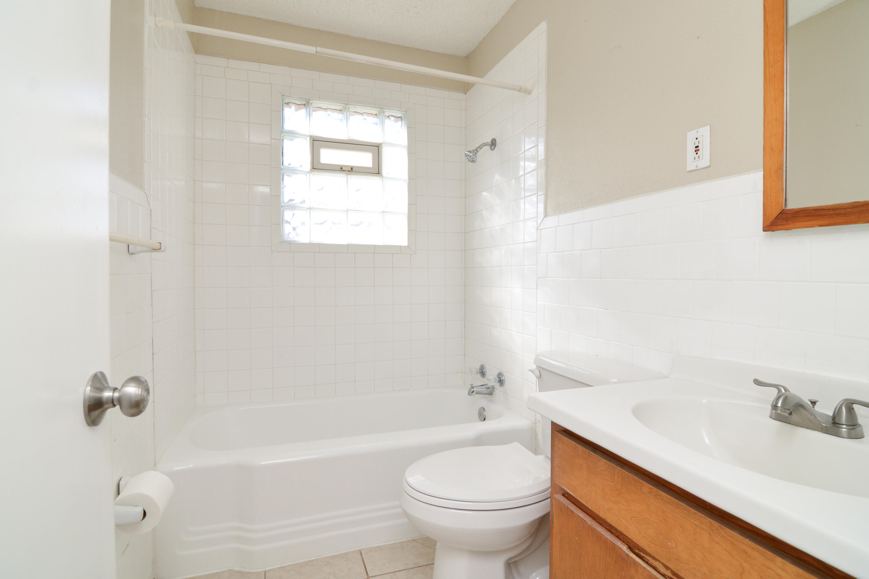 4907 41st Street Lubbock, TX 79414 - Photo 22 of 39 a bathroom with a sink toilet and shower