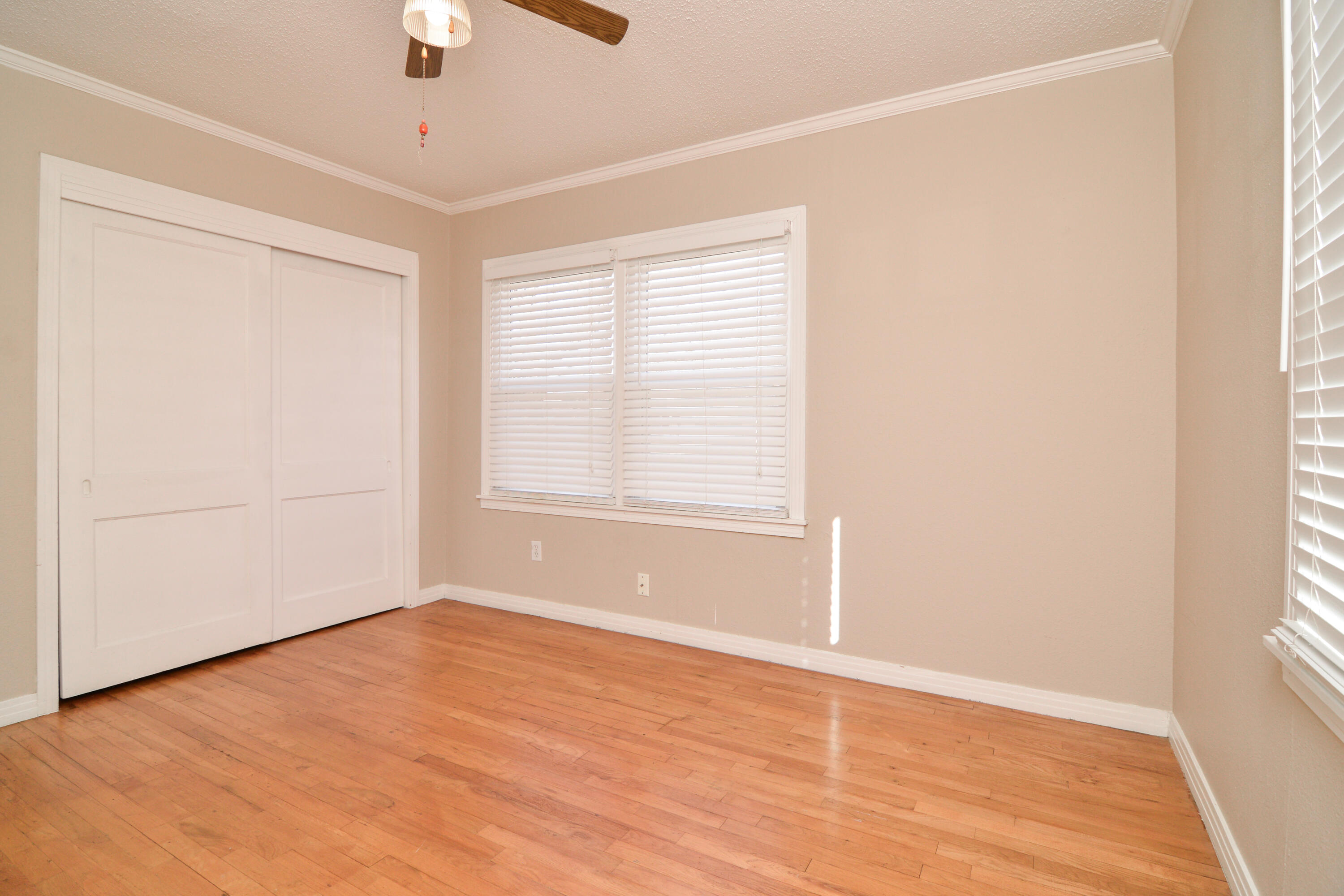 4907 41st Street Lubbock, TX 79414 - Photo 24 of 39 an empty room with wooden floor cabinet and windows