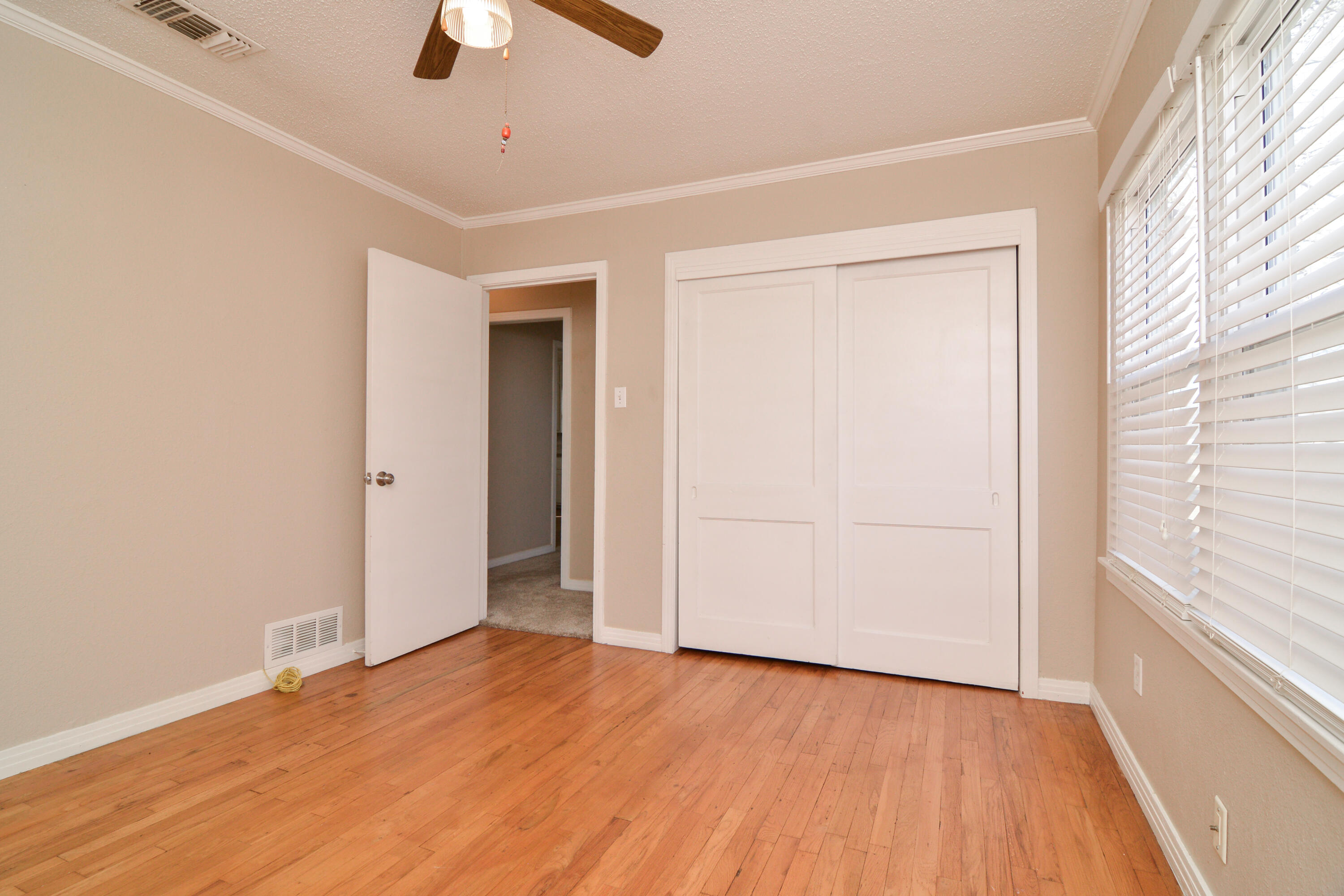 4907 41st Street Lubbock, TX 79414 - Photo 25 of 39 wooden floor in an empty room with a window