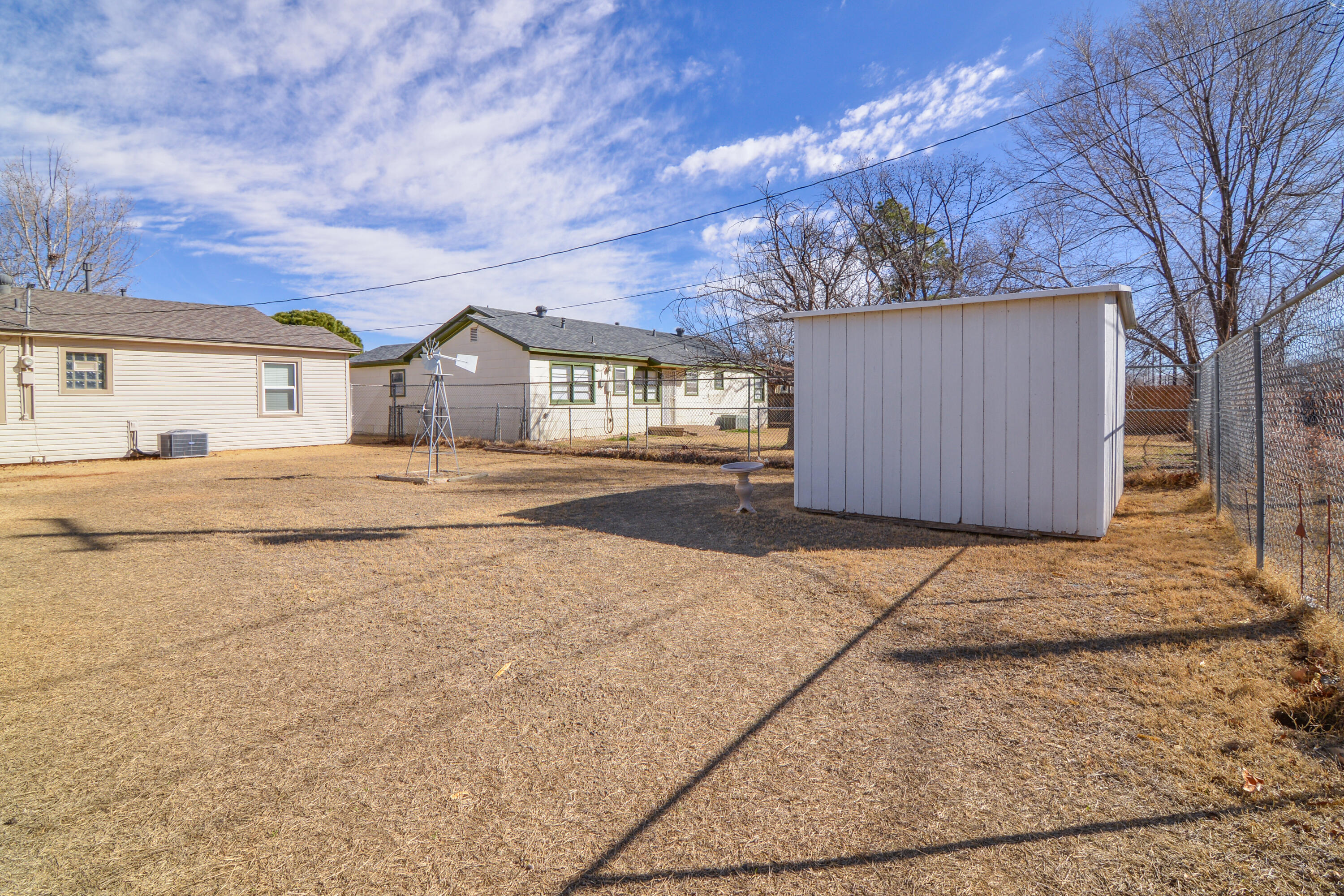 4907 41st Street Lubbock, TX 79414 - Photo 33 of 39 a front view of a house with a yard and garage