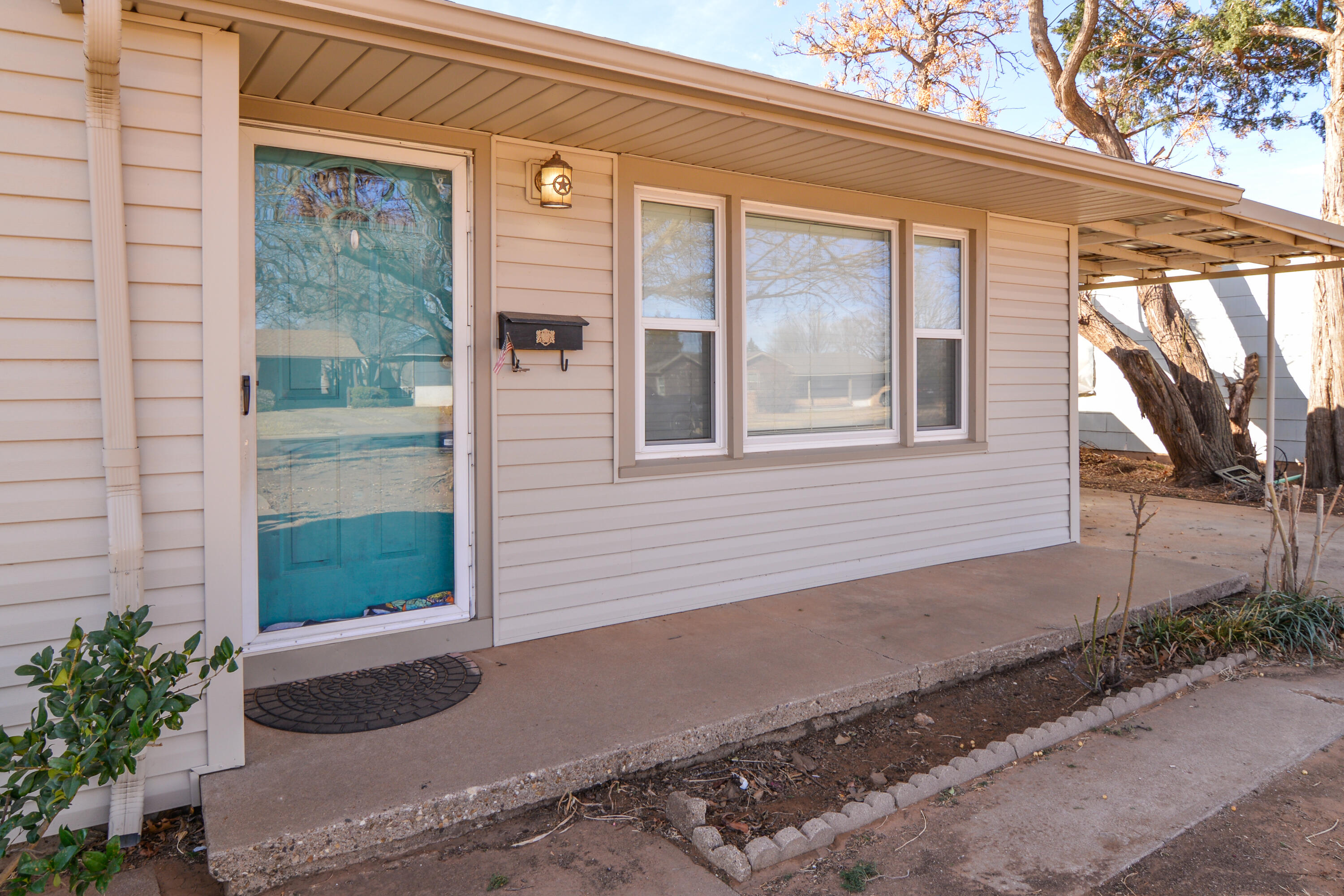 4907 41st Street Lubbock, TX 79414 - Photo 5 of 39 a front view of a house with a yard