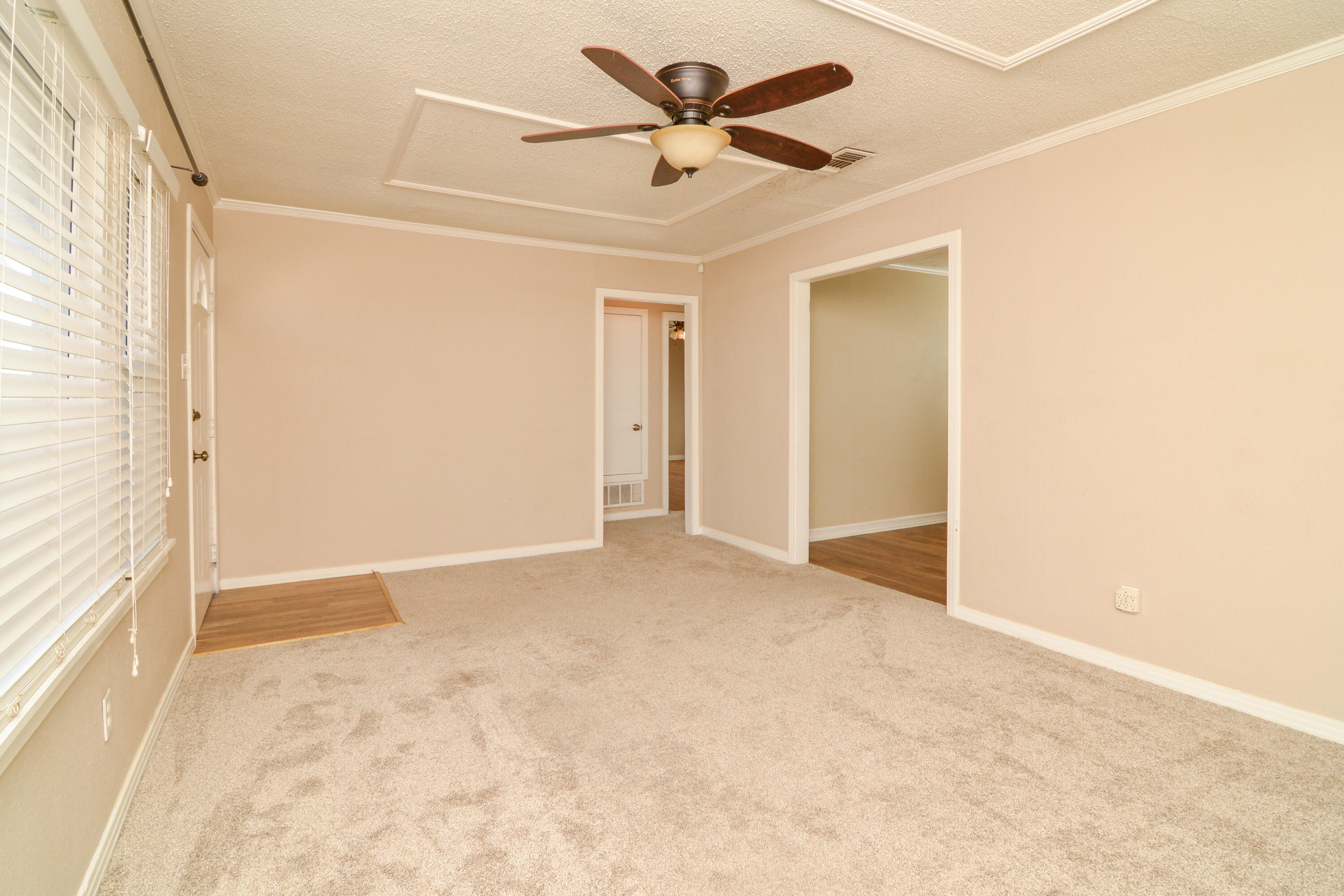 4907 41st Street Lubbock, TX 79414 - Photo 7 of 39 an empty room with fan and windows