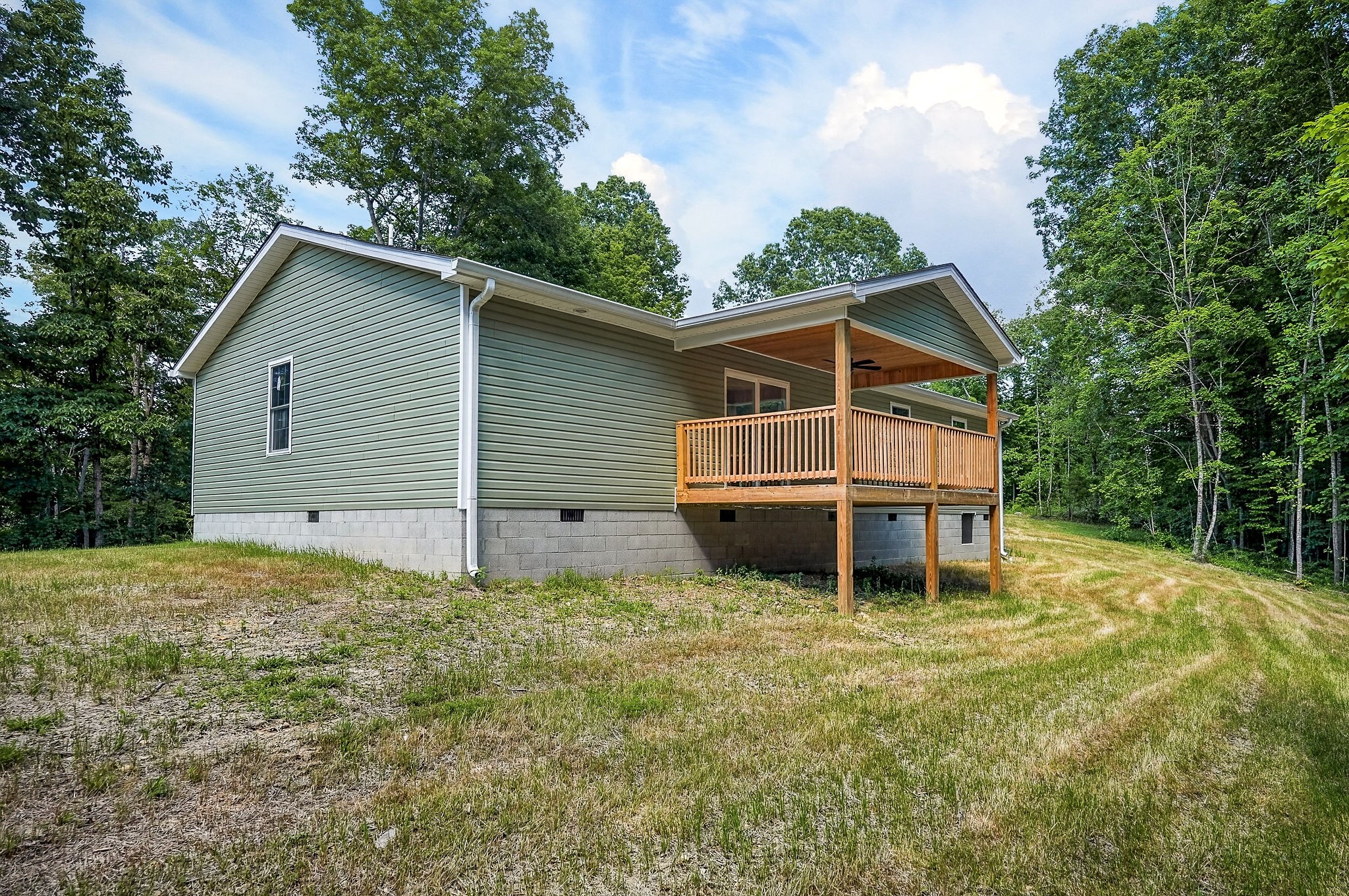 1053 Benton Tidwell Road Hilham, TN 38568 - Photo 26 of 39 a house with trees in the background