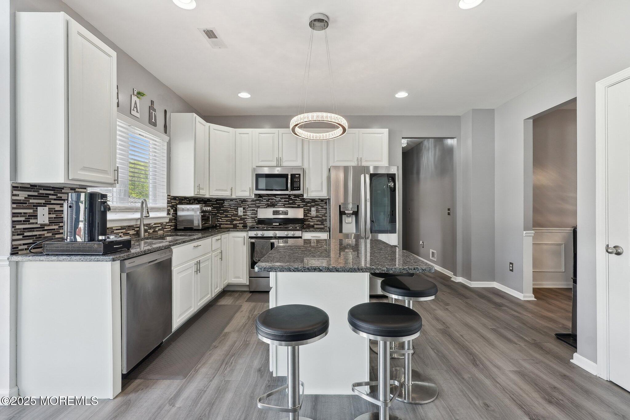4 Bridle Path Bayville, NJ 08721 - Photo 18 of 44 a kitchen with stainless steel appliances a refrigerator and a stove top oven