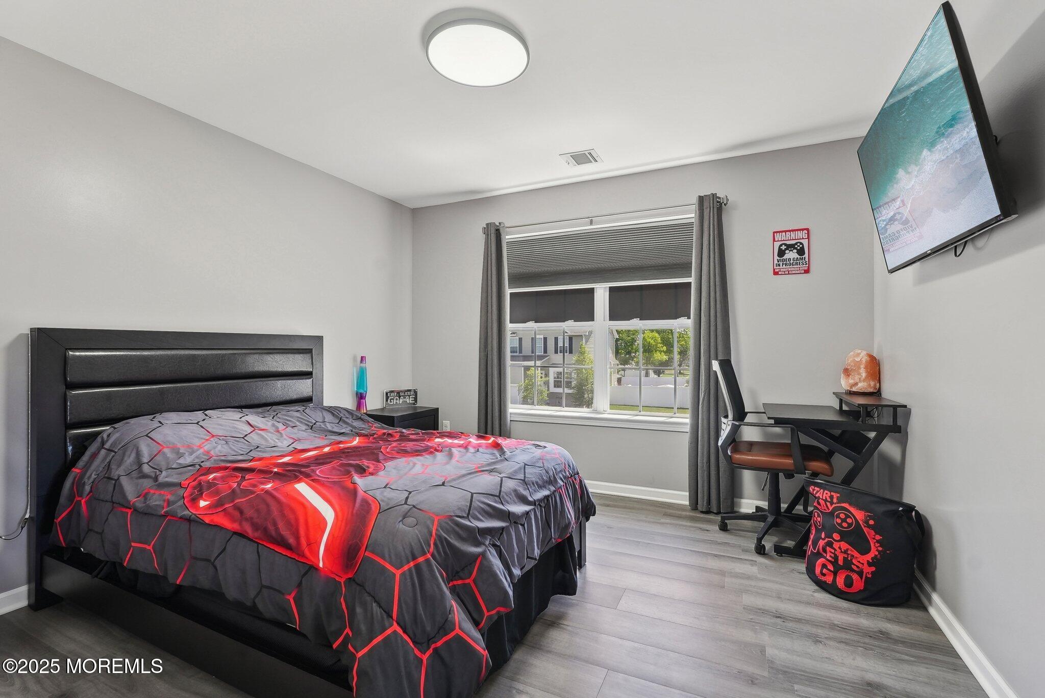 4 Bridle Path Bayville, NJ 08721 - Photo 22 of 44 a bedroom with a bed and wooden floor