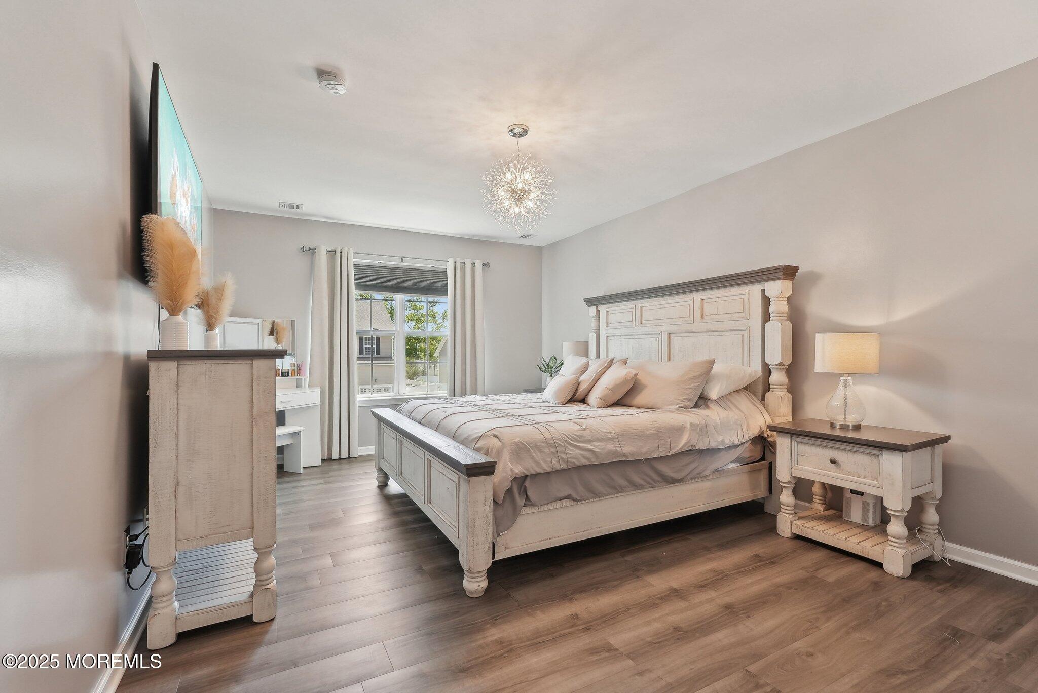4 Bridle Path Bayville, NJ 08721 - Photo 26 of 44 a bedroom with a bed and a flat tv screen on the dresser