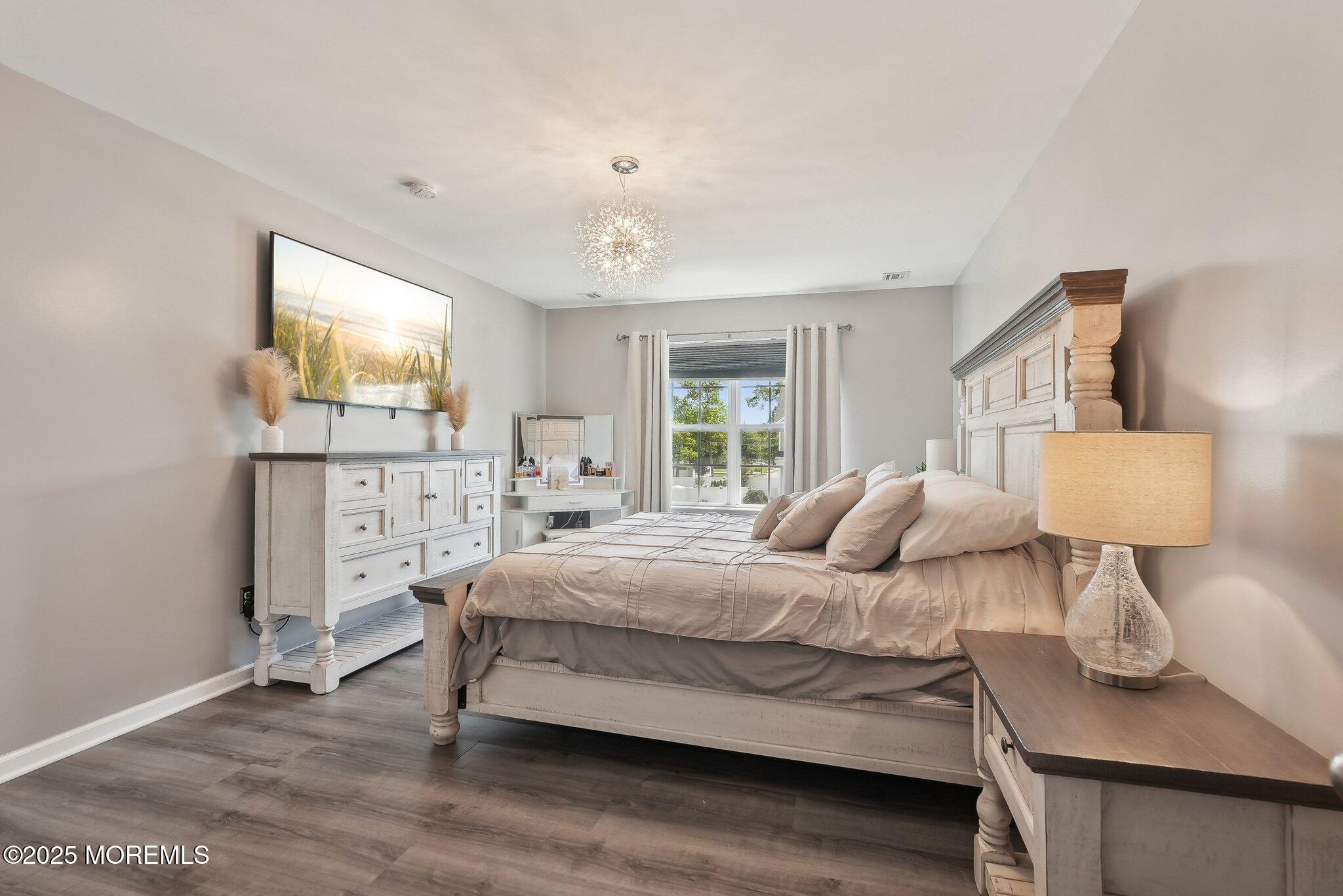 4 Bridle Path Bayville, NJ 08721 - Photo 29 of 44 a bedroom with a bed and wooden floor