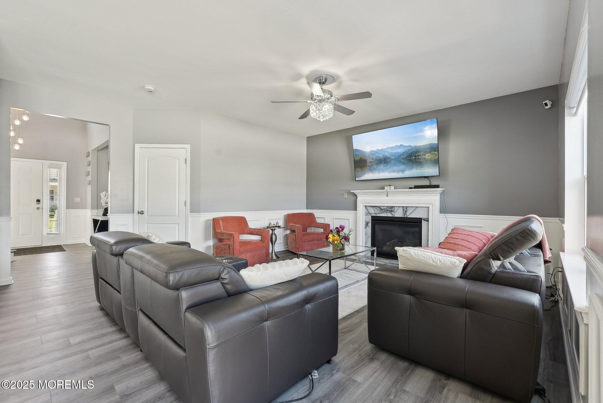 4 Bridle Path Bayville, NJ 08721 - Photo 3 of 44 a living room with furniture a fireplace and a flat screen tv