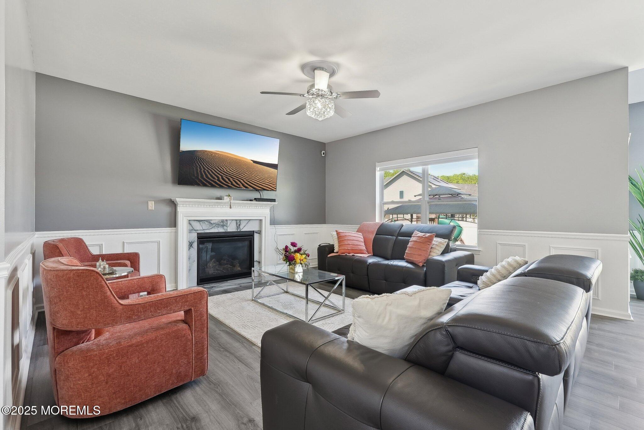 4 Bridle Path Bayville, NJ 08721 - Photo 4 of 44 a living room with furniture a fireplace and a flat screen tv