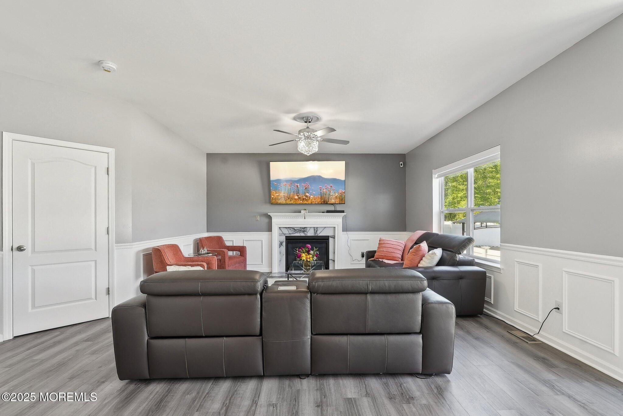 4 Bridle Path Bayville, NJ 08721 - Photo 5 of 44 a living room with furniture a fireplace and a window