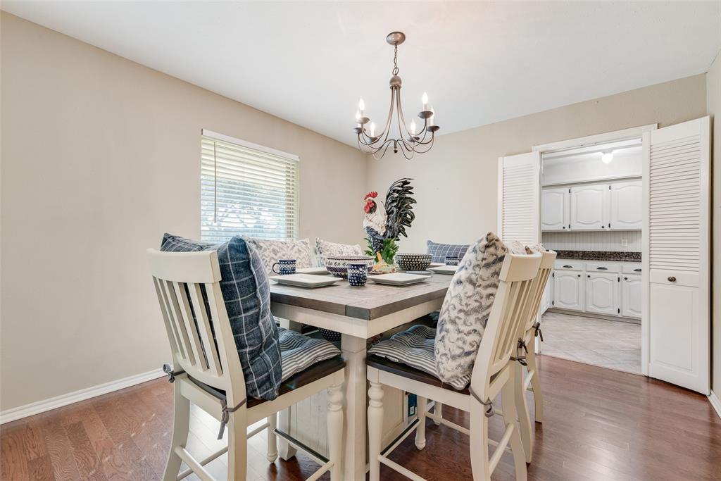 1923 Baylor Drive Richardson, TX 75081 - Photo 13 of 39 a view of a dining room with furniture and wooden floor