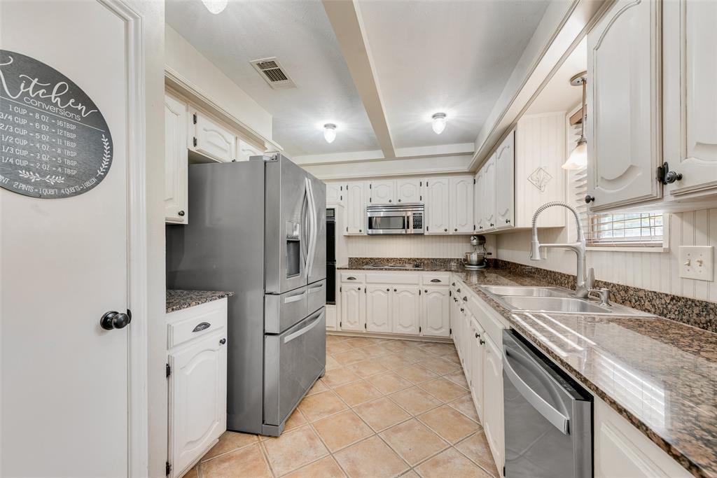 1923 Baylor Drive Richardson, TX 75081 - Photo 15 of 39 a kitchen with stainless steel appliances granite countertop a refrigerator and a sink