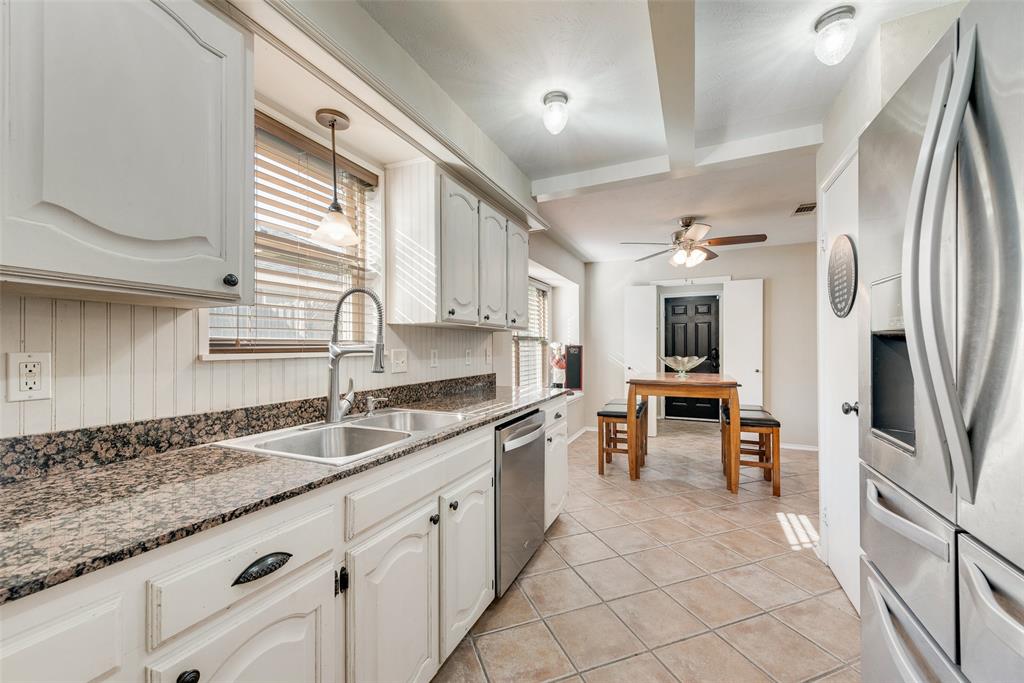 1923 Baylor Drive Richardson, TX 75081 - Photo 19 of 39 a kitchen with granite countertop a sink appliances cabinets and counter space