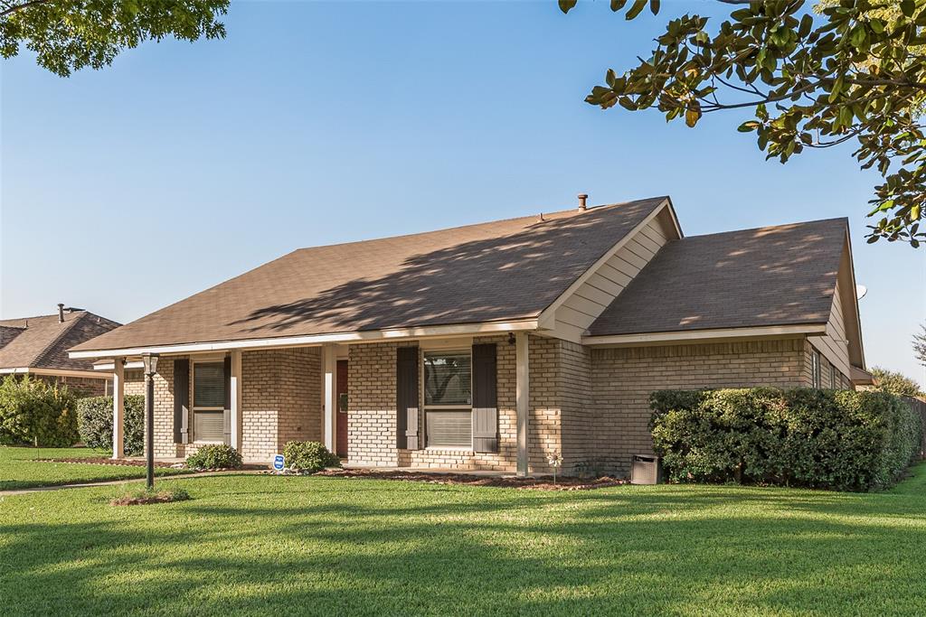 1923 Baylor Drive Richardson, TX 75081 - Photo 2 of 39 a front view of a house with a garden