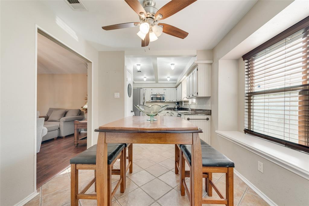 1923 Baylor Drive Richardson, TX 75081 - Photo 22 of 39 a kitchen with kitchen island a dining table and chairs