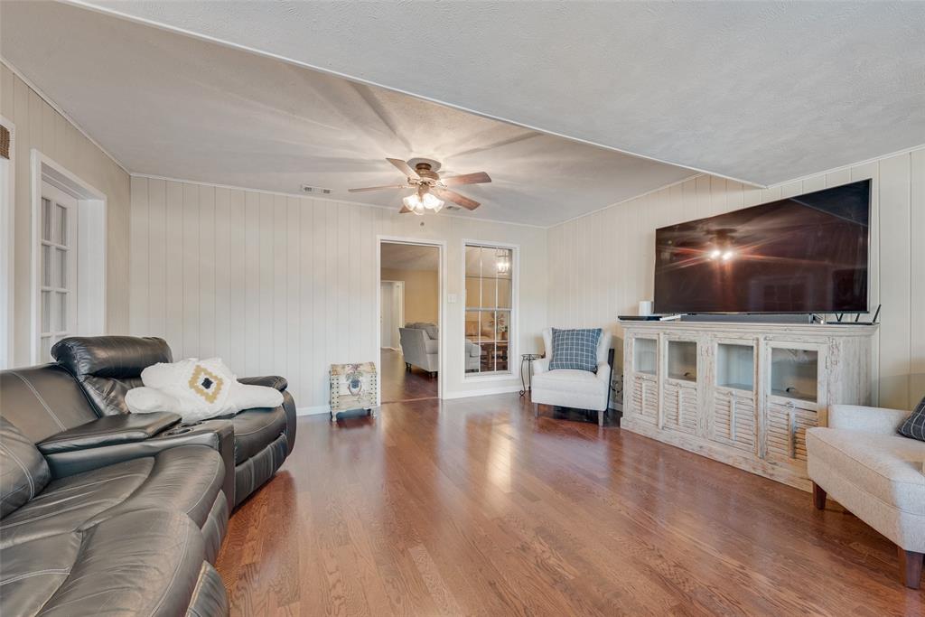 1923 Baylor Drive Richardson, TX 75081 - Photo 24 of 39 a living room with furniture and a flat screen tv