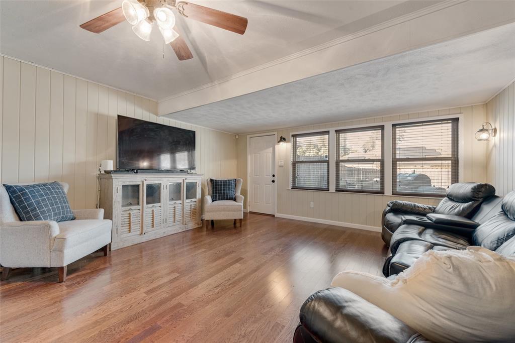 1923 Baylor Drive Richardson, TX 75081 - Photo 25 of 39 a living room with furniture and a flat screen tv