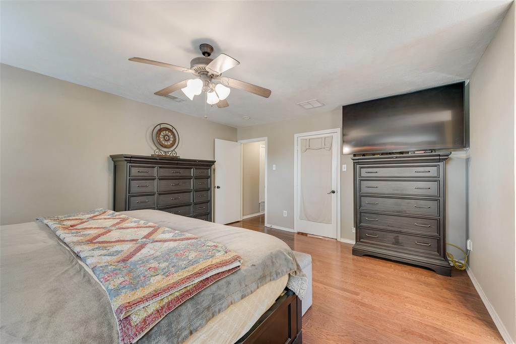 1923 Baylor Drive Richardson, TX 75081 - Photo 28 of 39 a bedroom with a bed and a chandelier